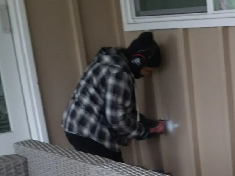 Professional electrician installing an exterior outlet in National City